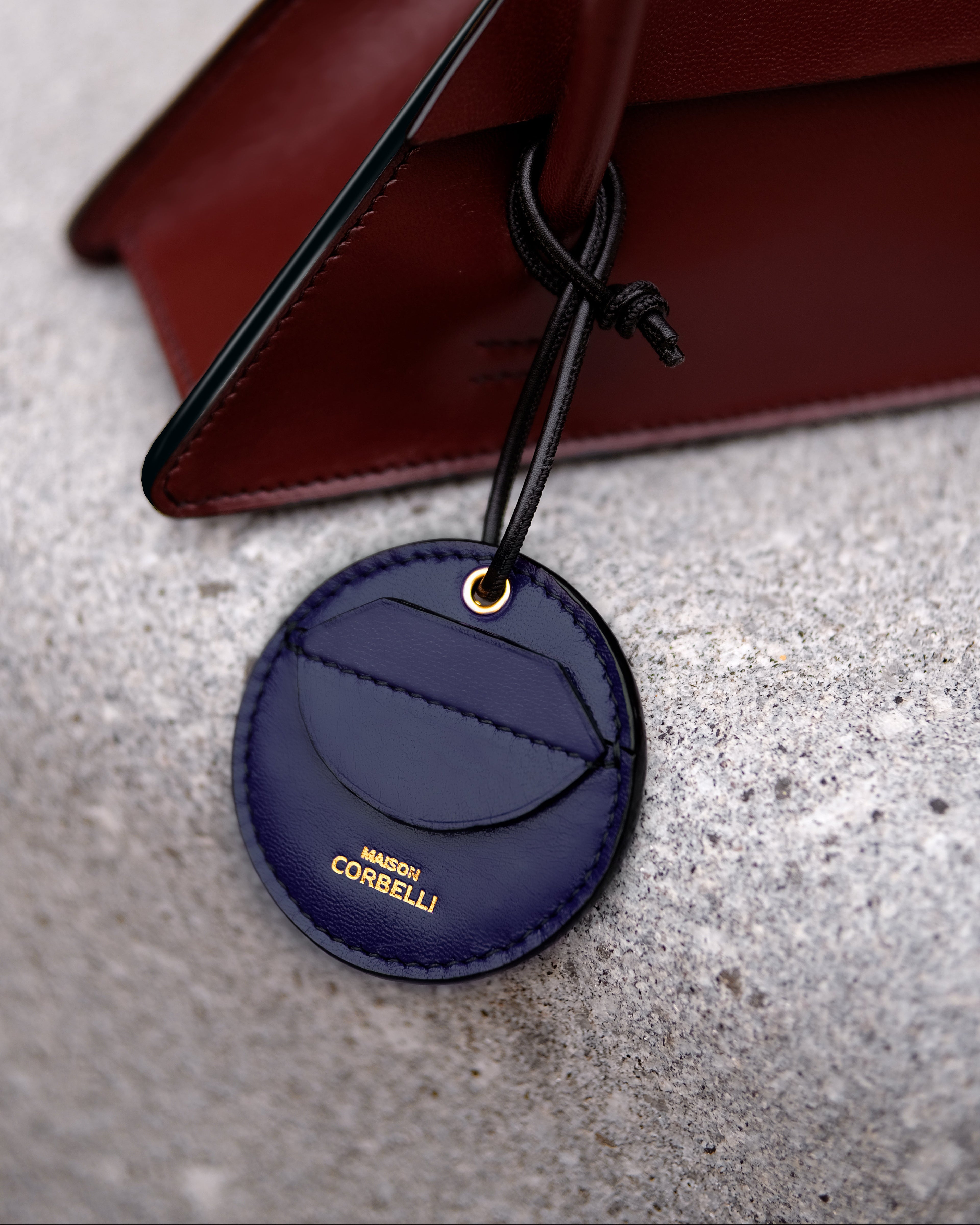 Oto, coin holder, gold-colored accessories, coin purse, few coins placed beside it, Front view, Model, Studio, Blue, bag, mediterranean vibe, Premium leather, Unique design, on a stone bench, Elie bag