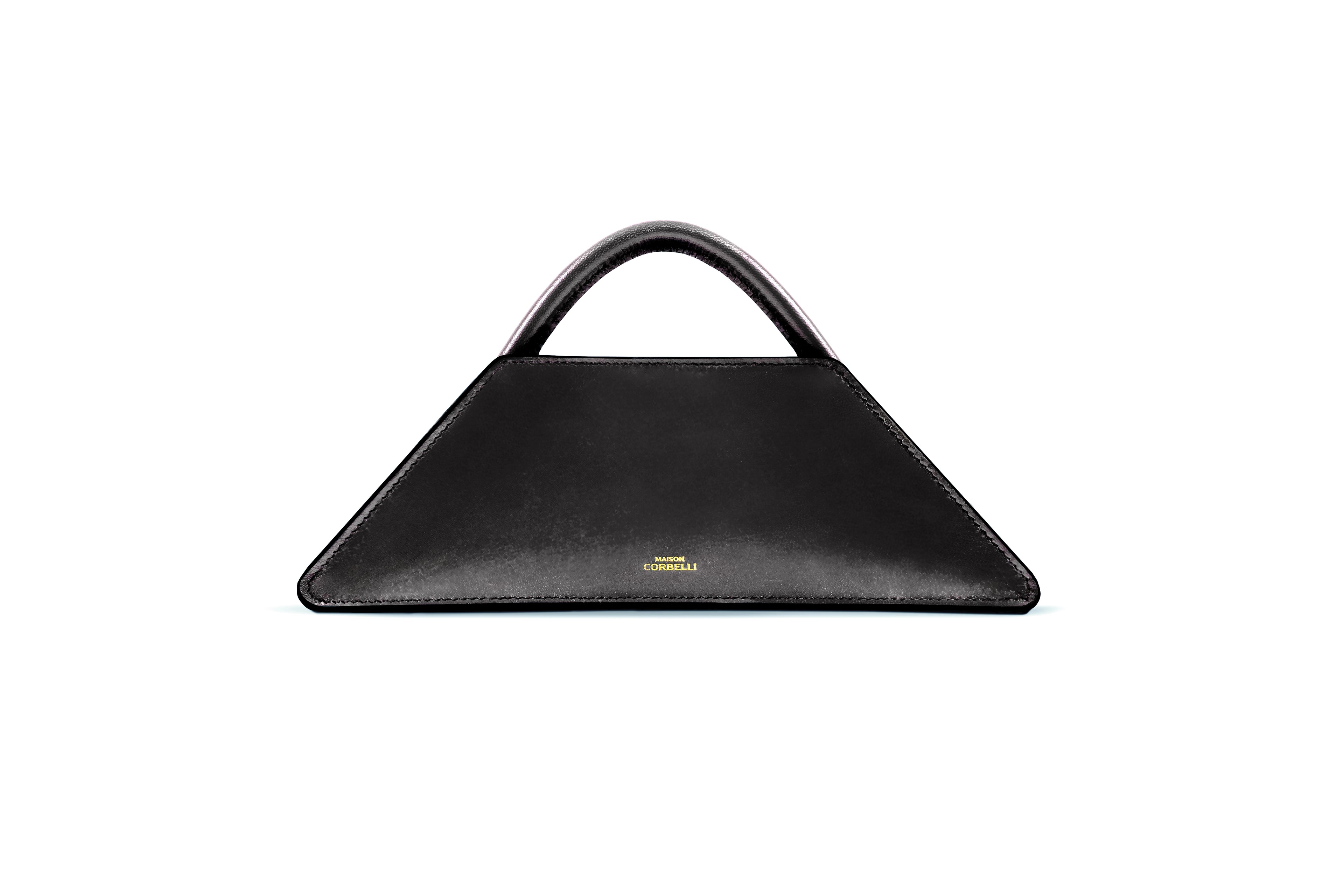 Maison Corbelli Elie Mini handhand in a Black obsidian colour front view standing in a studio with white background and sharp light. Golden logo with premium calf leather and a luxury look. Architectural look and mediteraneen vibes. Black obsidian Elie Mini Spanish calf leather crossbody bag, structured design, Model wearing the Elie Mini structured leather shoulder bag in black for lifestyle, Close-up of the gold-toned hardware and calfskin leather texture on the Elie Mini