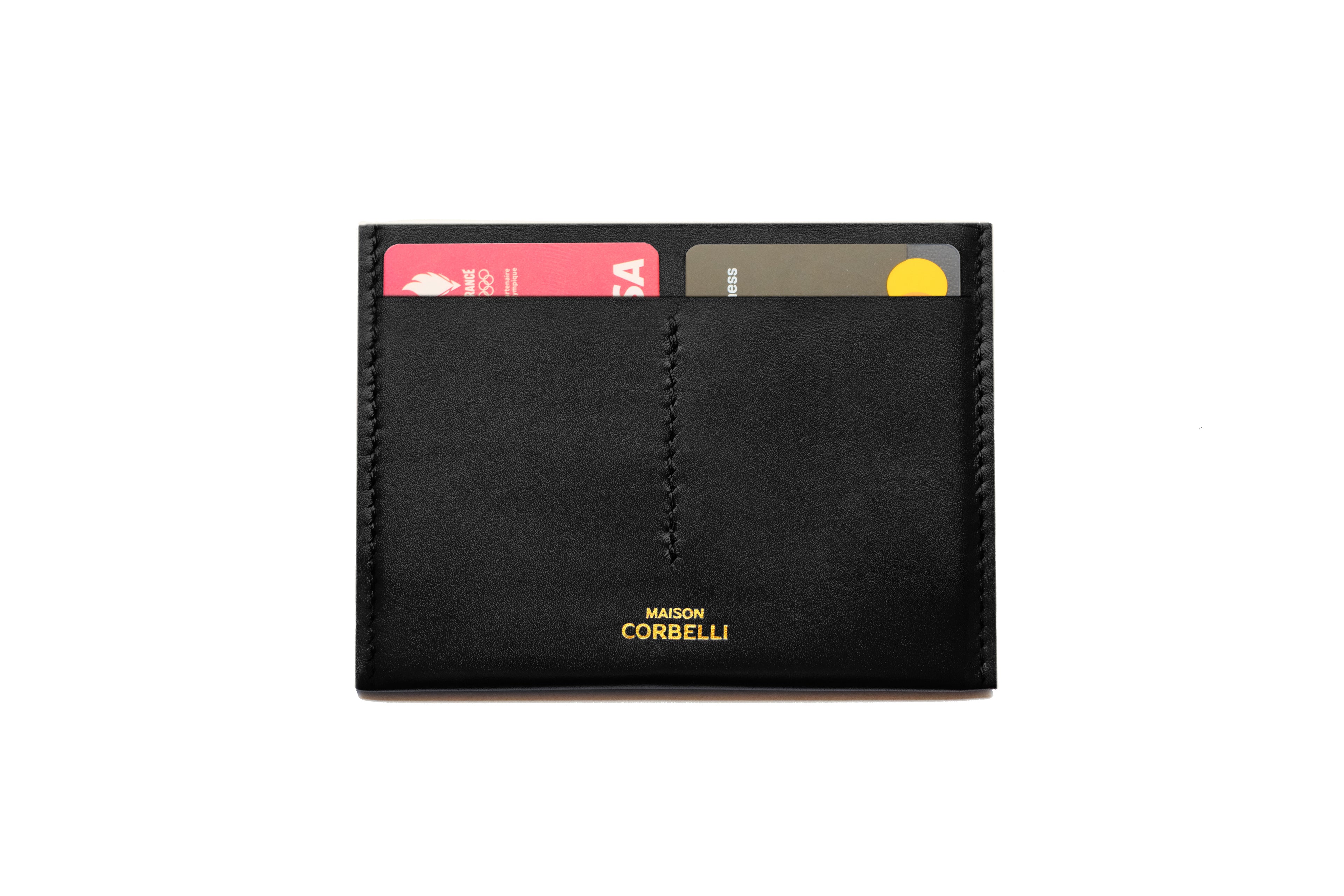 Maison Corbelli, Wally wallet card holder black obsidian colour, top view, from Maison Corbelli with a golden logo, on a white background,  with premium calf leather and a luxury look. Architectural look and mediteraneen vibes, two visible cards, include 4 cards plus a big storage