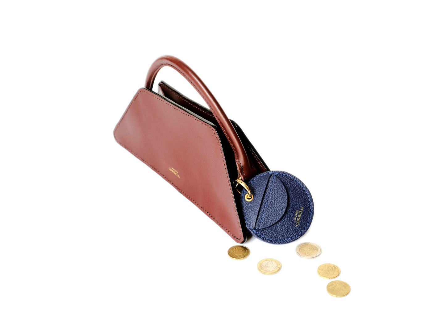 Oto, coin holder, gold-colored accessories, coin purse, Eli mini bag, purse, Hand bag, Clutch bag, few coins placed beside it, side view, hand Model, Studio, Burgundy, Blue, bag, mediterranean vibe, Premium leather, Unique design, Maison Corbelli, Luxury, grain calf leather