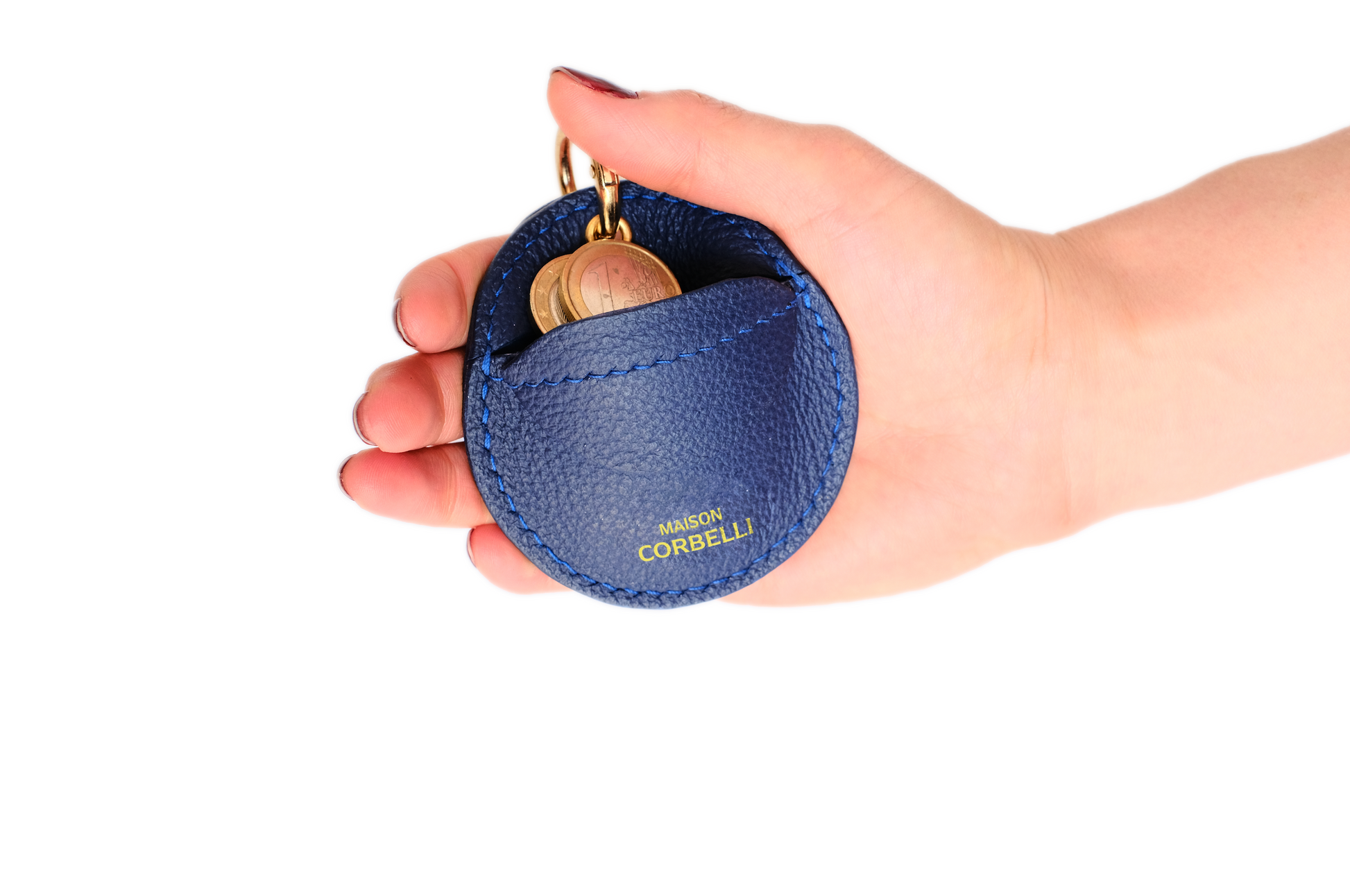 Oto, coin holder, gold-colored accessories, coin purse, few coins placed in it, top view, hand Model, Studio, Blue, bag, mediterranean vibe, Premium leather, Unique design, Maison Corbelli, Luxury, grain calf leather