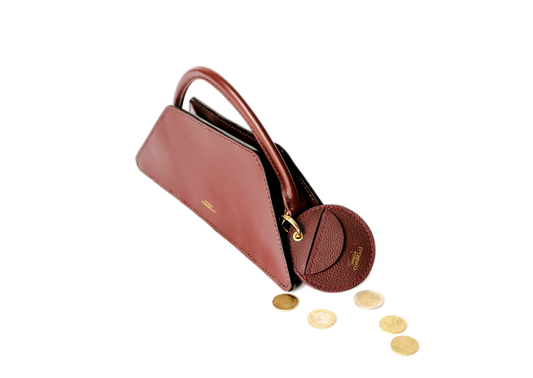 Oto, coin holder, gold-colored accessories, coin purse, Eli mini bag, purse, Hand bag, Clutch bag, few coins placed beside it, side view, hand Model, Studio, Burgundy, bag, mediterranean vibe, Premium leather, Unique design, Maison Corbelli, Luxury, grain calf leather