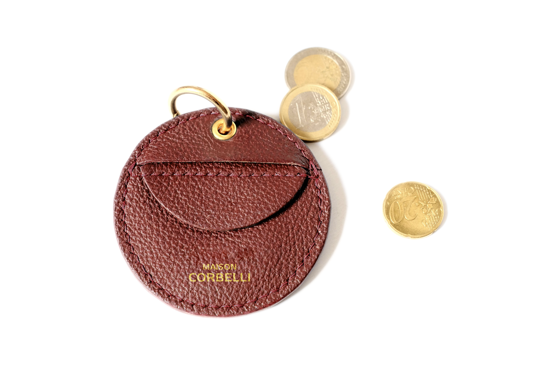 Oto, coin holder, gold-colored accessories, coin purse, few coins placed beside it, Front view, Model, Studio, Burgundy, bag, mediterranean vibe, Premium leather, Unique design, 
