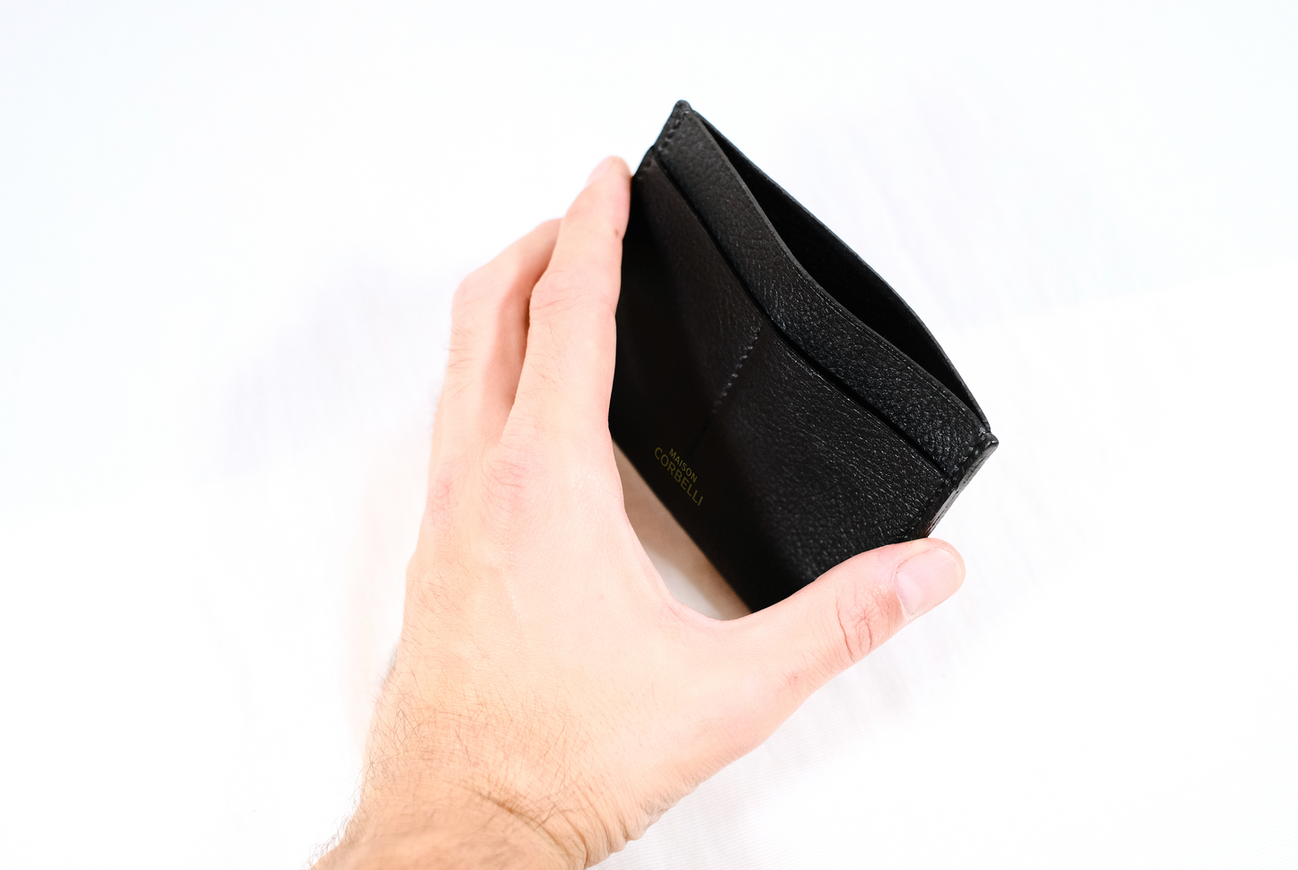 One wallet, black colour, on a white background, Wally wallet, top view, Pure leather, black colour, Passport size, studio photo, Close up open, hold in a hand
